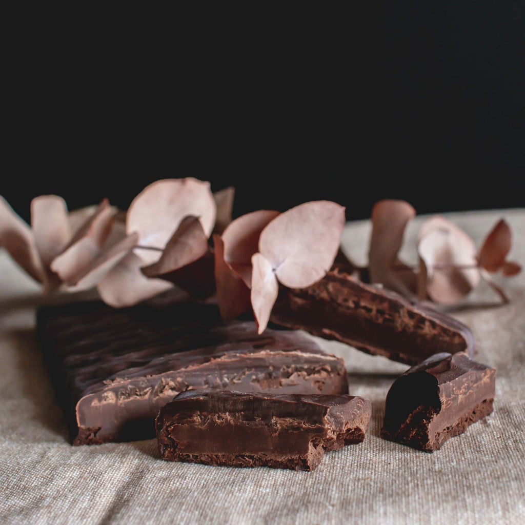 Porciones de turrón de chocolate trufado sobre un mantel, con hojas secas