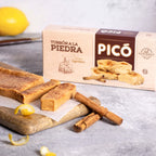 Barritas de turrón a la piedra con canela en rama y limón, junto a su caja Picó